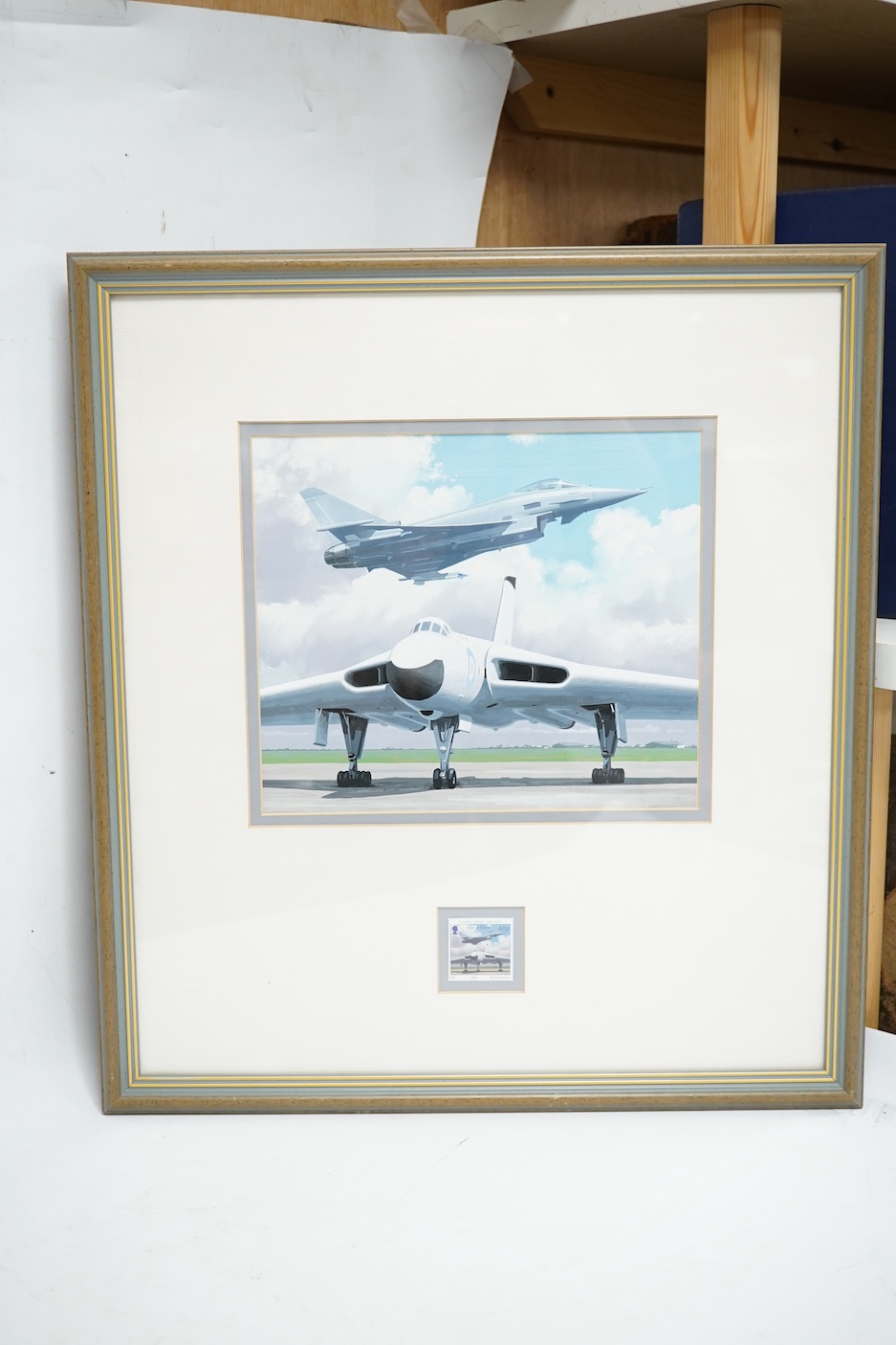 Keith Woodcock, an original gouache painting postage stamp design for an Isle of Man stamp featuring two RAF aircraft from different eras; the Avro Vulcan and the Eurofighter Typhoon, 20cm x 23.5cm, mounted and framed wi